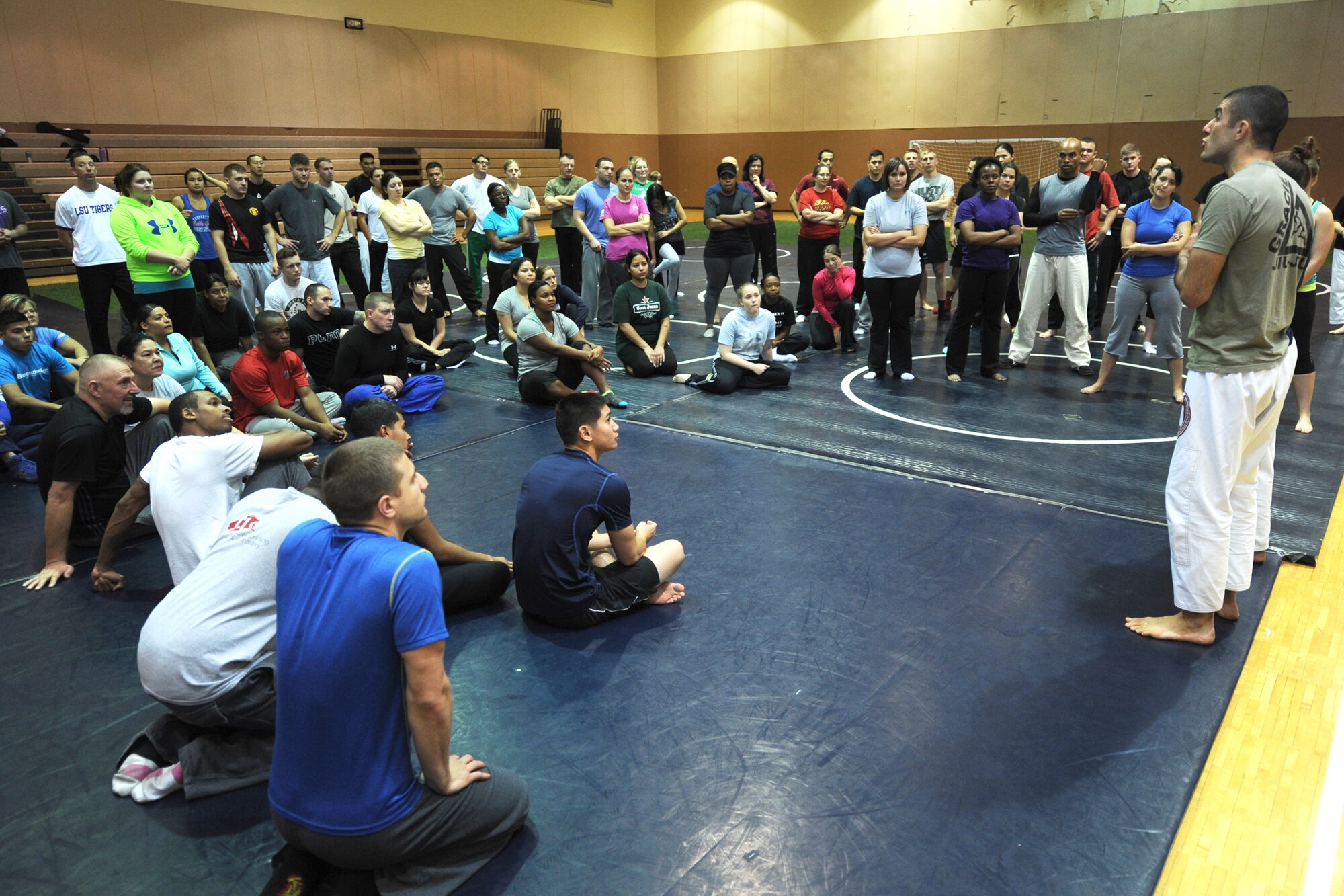 Rener Gracie, Gracie Academy Women Empowered self-defense seminar instructor, discusses various Gracie Jiu-Jitsu techniques to Team Malmstrom members at the base fitness center Nov. 12. The train-the-trainer course certified participants to teach the Gracie Defense Systems at future seminars (U.S. Air Force photo/Senior Airman Katrina Heikkinen)