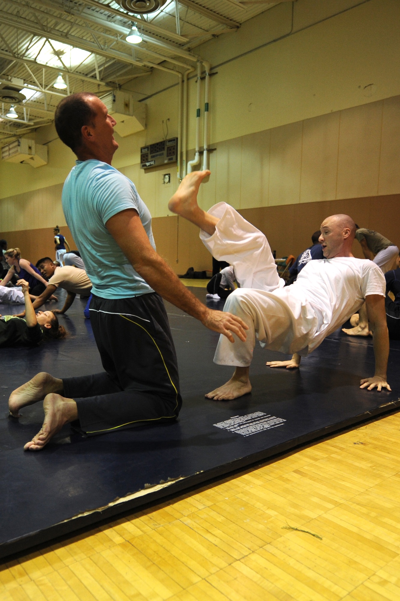 Adam Fruge, 341st Logistics Readiness Squadron hazardous materials supervisor (left), and Master Sgt. Robert Carroll, 490th Missile Squadron member, practice a self-defense scenario during a Gracie Academy Women Empowered self-defense seminar. Malmstrom Air Force Base is the third military installation to receive weeklong seminars based on Gracie Jiu-Jitsu techniques. (U.S. Air Force photo/Senior Airman Katrina Heikkinen