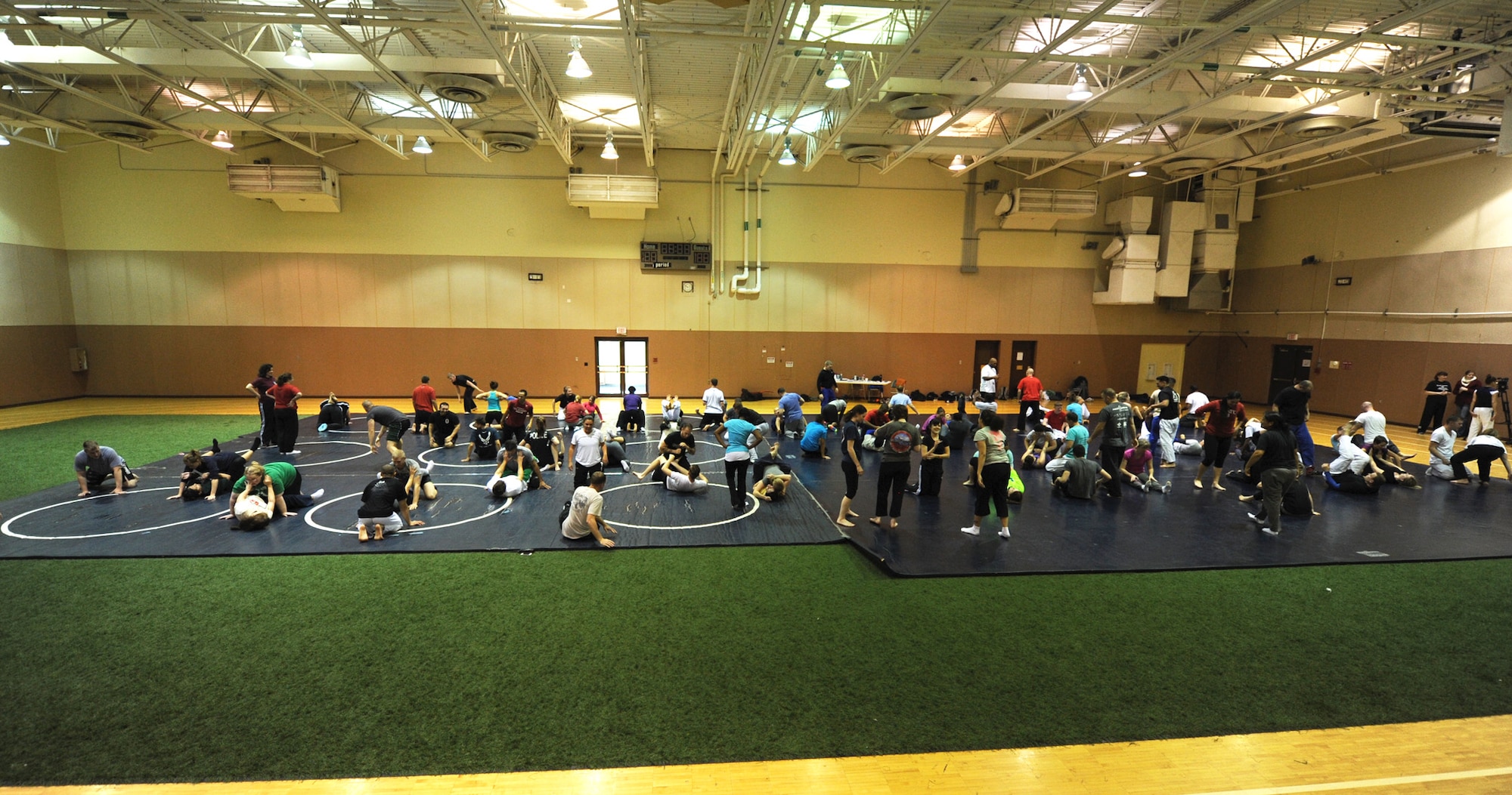 Nearly 100 Team Malmstrom members practice a self-defense scenario during a seminar at the fitness center Nov. 12. The program was tailored to target sexual assault scenarios by teaching Gracie Jiu-Jitsu techniques. (U.S. Air Force photo/Senior Airman Katrina Heikkinen)