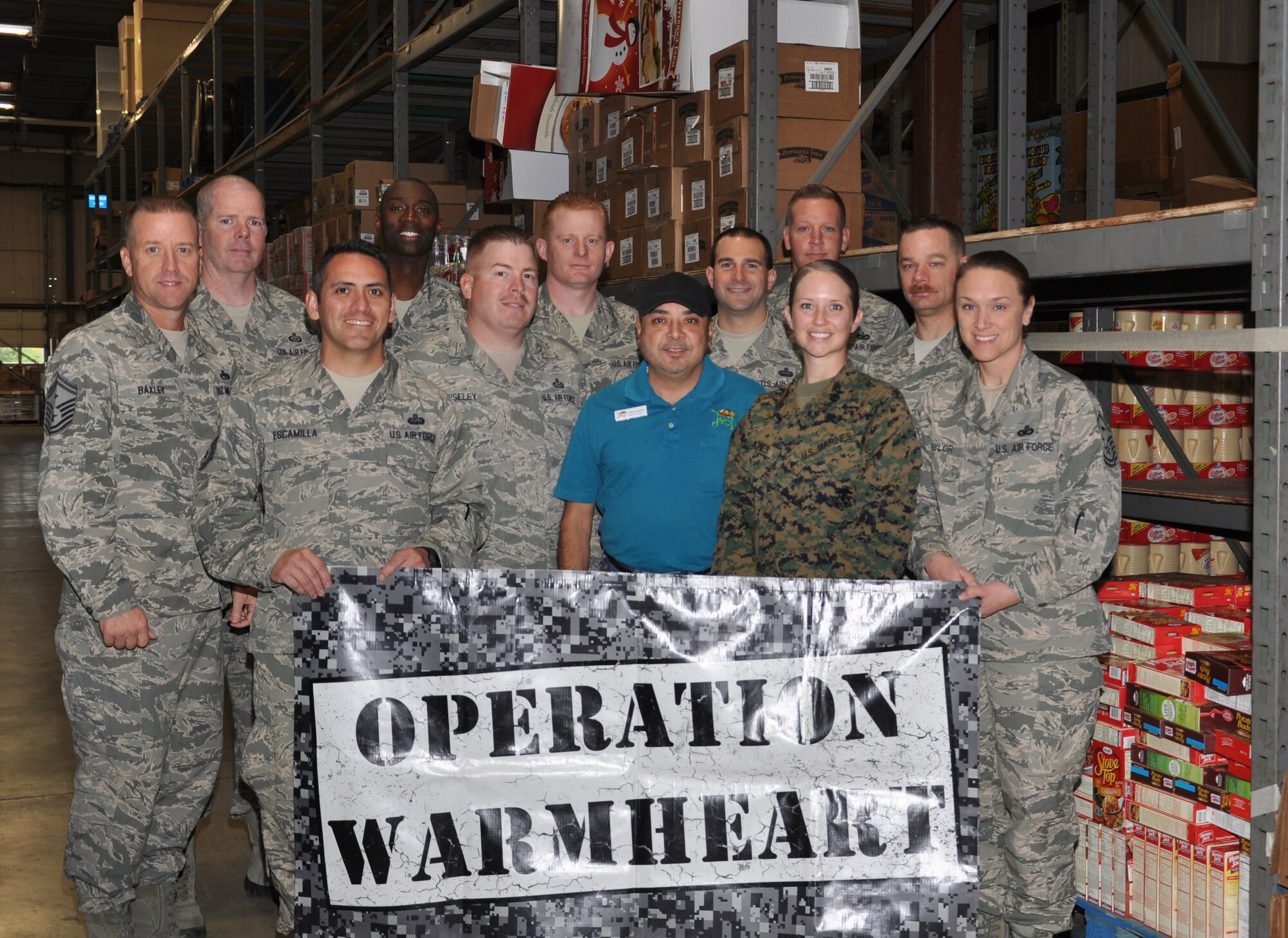 GOODFELLOW AIR FORCER BASE, Texas- Members from the First Sergeants’ Council stand in front of donations collected for Operation Warmheart at the Base Commissary Nov. 14. Operation Warmheart is an Air Force First Sergeant program provided at Goodfellow throughout the year to help any base personnel in need. (U.S. Air Force photo/ Airman 1st Class Erica Rodriguez)