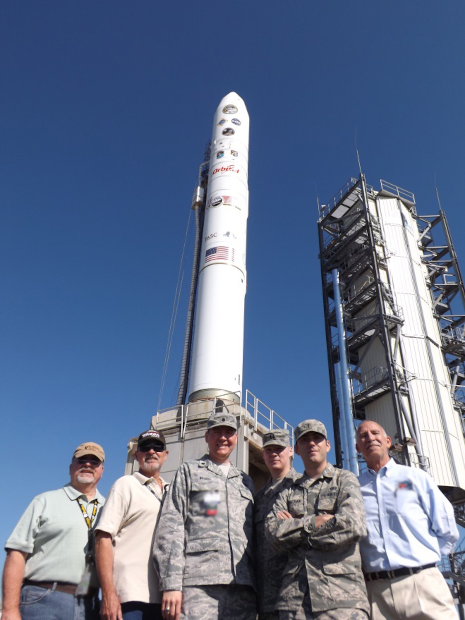 The U.S. Air Force's Launch Systems Division Launch Operations Team stand beside the Orbital Sciences Minotaur V.  From left to right are Mr. Keith Witt (AeroThermo Technology Inc.); Mr. John Wee (TASC); Lt. Col. Jeff Wiemeri, SDL Chief of Launch Operations;  Capt. Mike Moen, SDL Minotaur V Mission Manager; 1st Lt. Justin Oryschak, SDL Deputy Mission Manager and Mr. Paul Carman (TASC). (US Air Force photo)