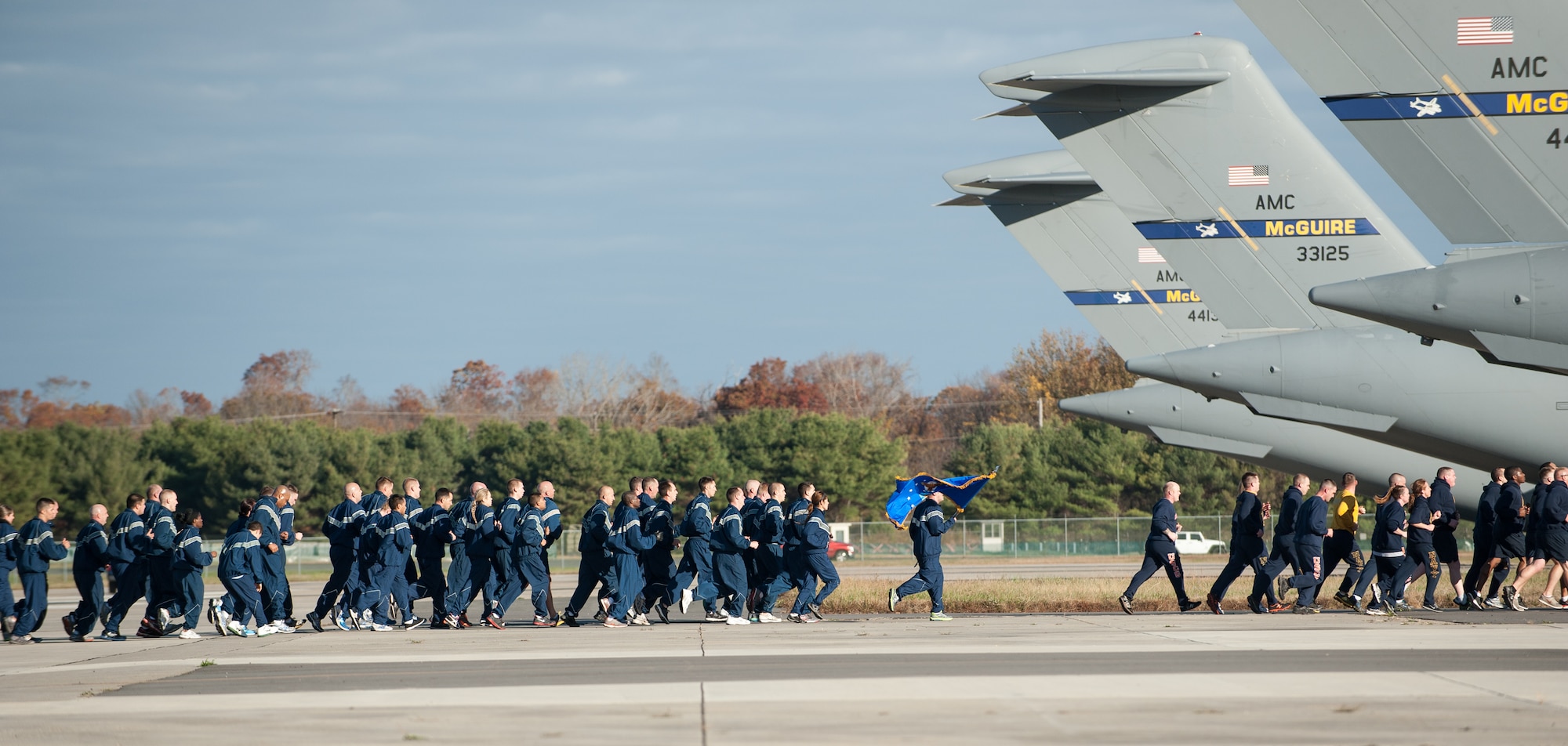 Members from each branch of service, Army, Navy, Air Force, Marines and Coast Guard, participate in a Veterans Day Run Nov. 10, 2013, at Joint Base McGuire-Dix-Lakehurst, N.J. The event commemorates the sacrifices that veterans of the past and present have endured for their country and to promote espirit de corps across the joint base. (U.S. Air Force photo by Russ Meseroll/Released)