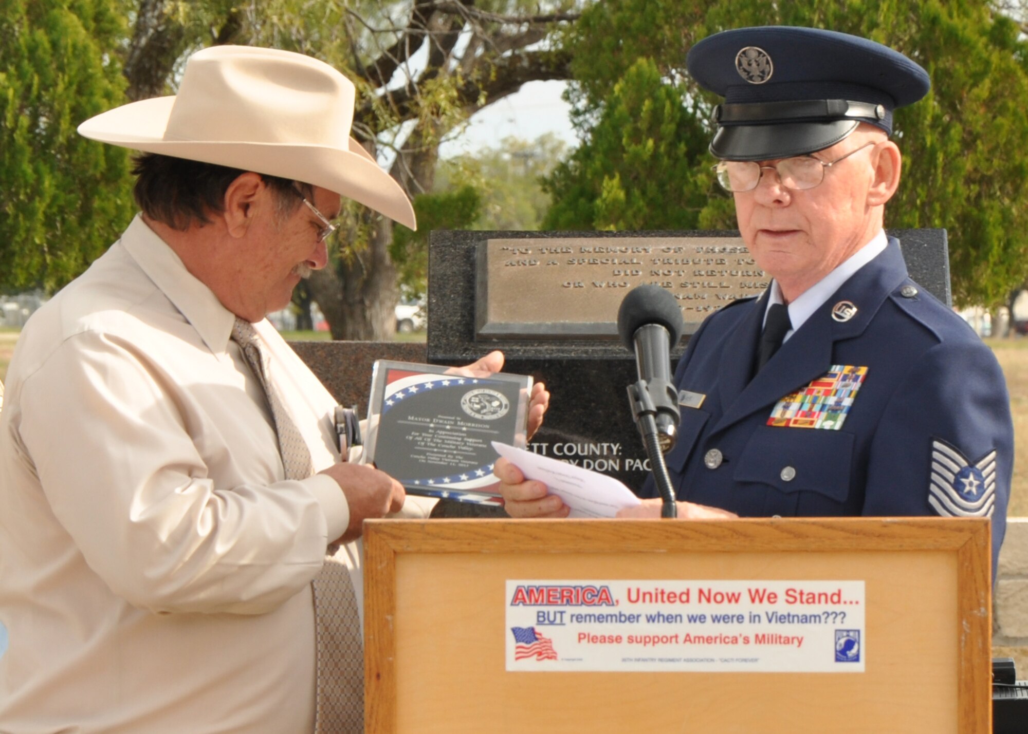 SAN ANGELO, Texas - Retired Master Sgt. Tom Davis presents Dwain Morrison, San Angelo mayor, with a plaque for his years of service to the military community in San Angelo during the Veterans Day observance at Mathis Field Vietnam Memorial Nov. 11. Morrison expressed his gratitude and pride for all veterans who have supported the U.S. (U.S. Air Force photo/ Airman 1st Class Joshua Edwards)