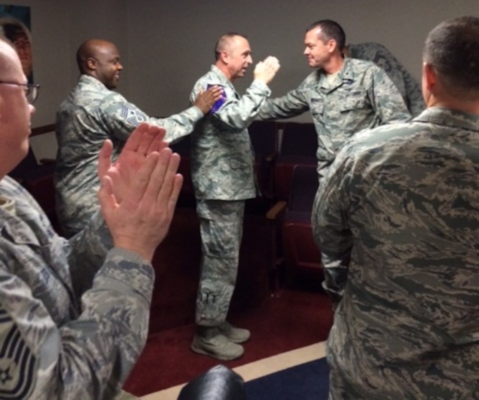Senior Master Sgt. Craig Pogue (center), 82nd Training Wing Training Operations superintendent, gets congratulated by Brig. Gen. Scott Kindsvater (right), 82nd TRW commander and Chief Master Sgt. Eric Johnson, 82nd TRW command chief, after learning he had been selected for promotion to chief master sergeant Nov. 14, 2013.  Three members of Team Sheppard were selected for the promotion. (U.S. Air Force courtesy photo)
