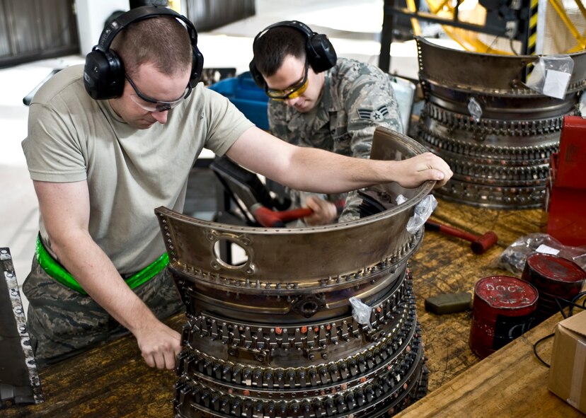 U.S. Air Force Staff Sgt. David Lawson (left), and Senior Airman Cody Girard, both assigned to the 7th Component Maintenance Squadron, repair a component of a General Electric F101-102 turbofan jet engine from a B-1B Lancer, Nov. 13, 2013, at Dyess Air Force Base, Texas. Aerospace Propulsion technicians perform routine maintaince, diagnose, and repair jet engines. Four of these F101-102 engines are used to power the B-1B Lancer. (U.S. Air Force photo by Staff Sgt. Richard Ebensberger/Released)