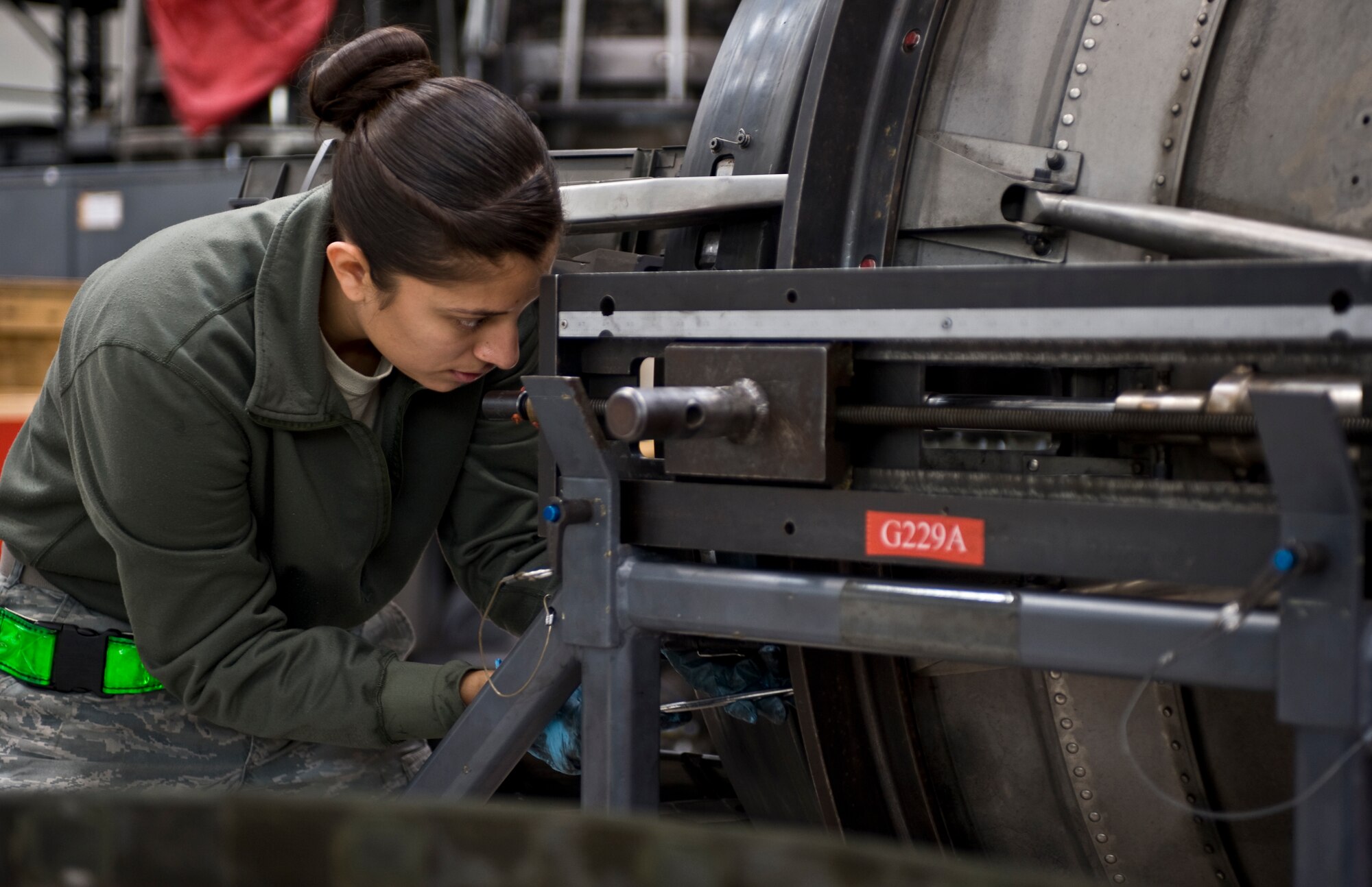 U.S. Air Force Senior Airman Catalina Cornejo, 7th Component Maintenance Squadron, installs a primary flap onto the exhaust nozzle of General Electric F101-102 turbofan jet engine from a B-1B Lancer, Nov. 13, 2013, at Dyess Air Force Base, Texas. The F101 is an afterburning turbofan jet engine. Afterburners are designed to provide an increase in thrust allowing for supersonic flight, faster takeoffs and increased speed during combat situations. (U.S. Air Force photo by Staff Sgt. Richard Ebensberger/Released)