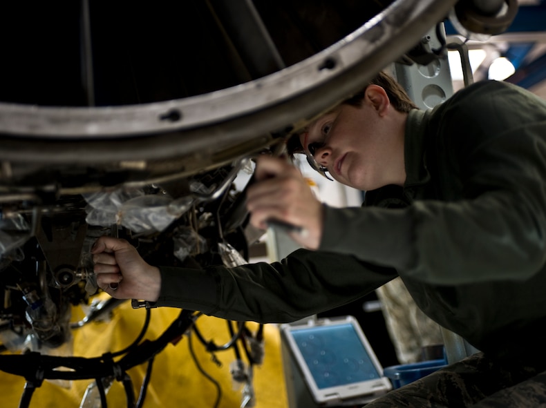 U.S. Air Force Senior Airman Shelby Fields, 7th Component Maintenance Squadron, disassembles a General Electric F101-102 turbofan jet engine from a B-1B Lancer, Nov. 13, 2013, at Dyess Air Force Base, Texas. Fields had to dissemble the engine in order to inspect and replace some damaged components. (U.S. Air Force photo by Staff Sgt. Richard Ebensberger/Released)