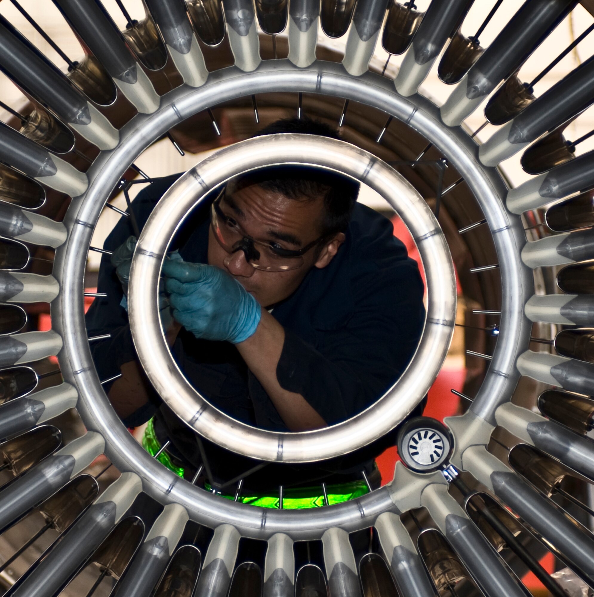 U.S. Air Force Senior Airman David Do, 7th Component Maintenance Squadron, repairs the augmentor of a General Electric F101-102 turbofan jet engine from a B-1B Lancer, Nov. 13, 2013, at Dyess Air Force Base, Texas. The F101 is rated in the 30,000-pound thrust class and was General Electric's first turbofan engine with an augmentor. (U.S. Air Force photo by Staff Sgt. Richard Ebensberger/Released)