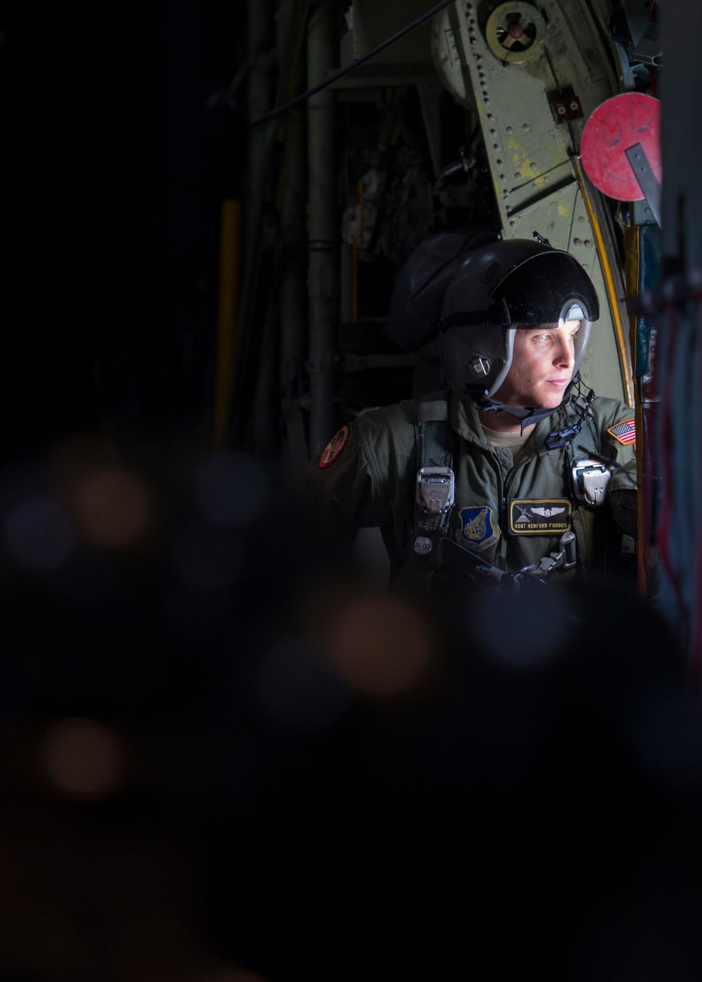 Staff Sgt. Renford Forbes, 36th Airlift Squadron loadmaster, looks out the rear door window of an U.S. Air Force C-130 Hercules during exercise Cope South over Bangladesh, Nov. 10, 2013. Forbes and approximately 80 U.S. Airmen participated in the exercise which promoted teamwork and friendship between U.S. and Bangladeshi servicemembers. (U.S. Air Force photo by Captain Raymond Geoffroy/Released)