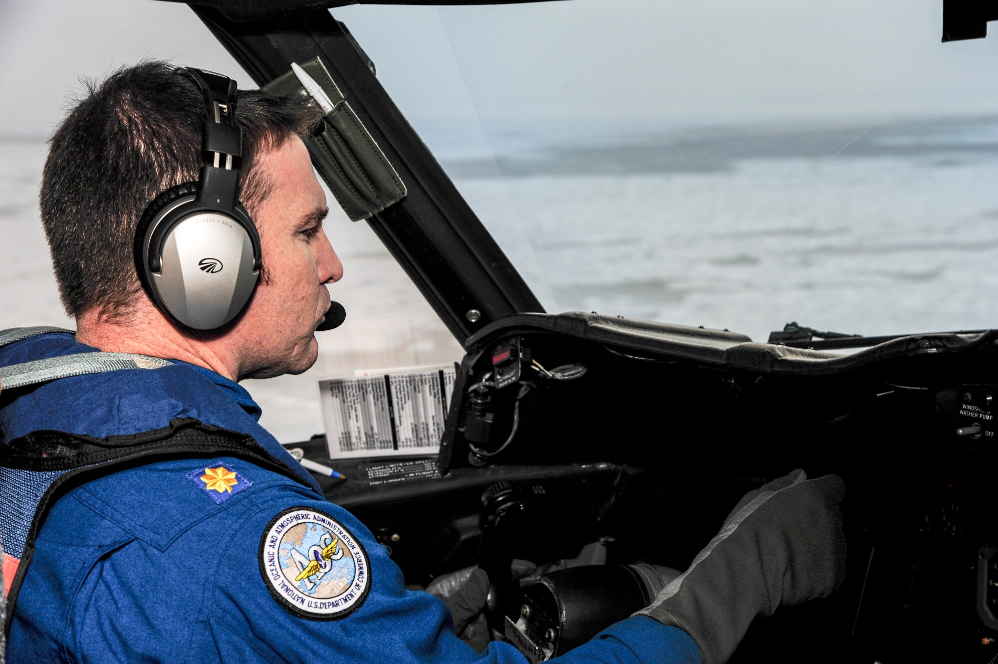 Lt. Cmdr. Patrick Didier, National Oceanic and Atmospheric Administration WP-3D pilot, checks an instrument while flying over the Chukchi Sea Oct. 30, 2013. NOAA’s goal was to inspect the different variables in the air mass that relate to heat fluxes and how they affect the Arctic region. (U.S. Air Force photo by Senior Airman Zachary Perras/Released)