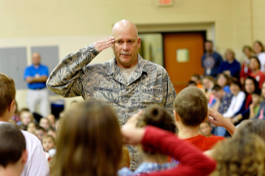 MARYVILLE, Tenn. - Tech. Sgt. Mike Anderson with the 134th Air Refueling Wing, Tennessee Air National Guard, shows students from Montvale Elementary School here, Nov. 6, 2013, how to salute during a morning veteran's appreciation event inside the school's gymnasium. About a dozen Air National Guard members from McGhee Tyson Air National Guard Base joined with other area veterans who were thanked for their service by more than 200 children and their teachers.  (U.S. Air National Guard photo by Master Sgt. Mike R. Smith/Released)