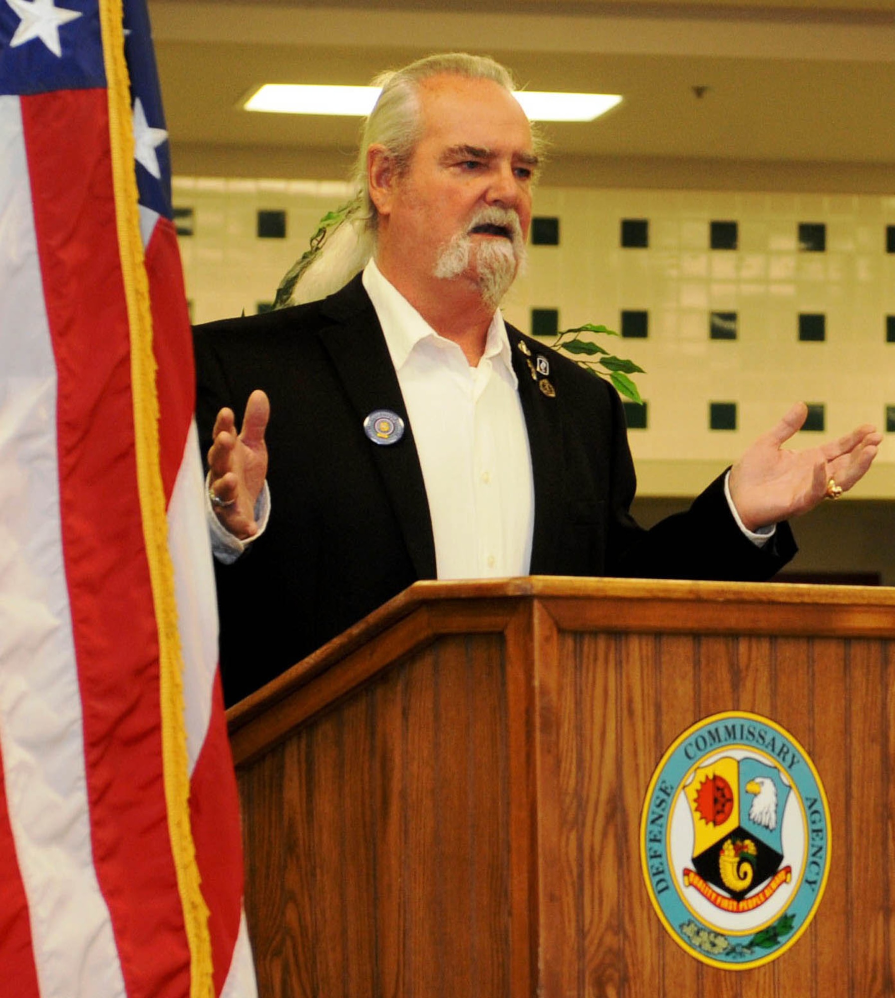 Niles Harris, retired Army Master Sgt. and Vietnam veteran, spoke during a flag-unveiling ceremony in the base Commissary at Ellsworth Air Force Base, S.D. Nov. 8, 2013. Airmen, family members, civilians and base leaders came together to celebrate the service and sacrifices of our nations Vietnam war veterans. (U.S. Air Force photo by Airman 1st Class Rebecca Imwalle / Released)