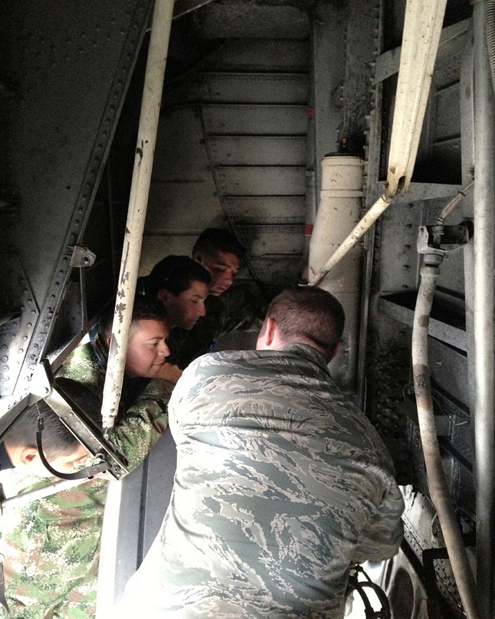 Tech. Sgt. Jason Sanderson, a crew chief in the Kentucky Air National Guard’s 123rd Global Mobility Squadron, trains maintainers from the Columbia Air Force on the components of a C-130 aircraft Main Landing Gear System during a training event held in Bogota, Columbia, in August and September 2013. (U.S. Air National Guard Photo)