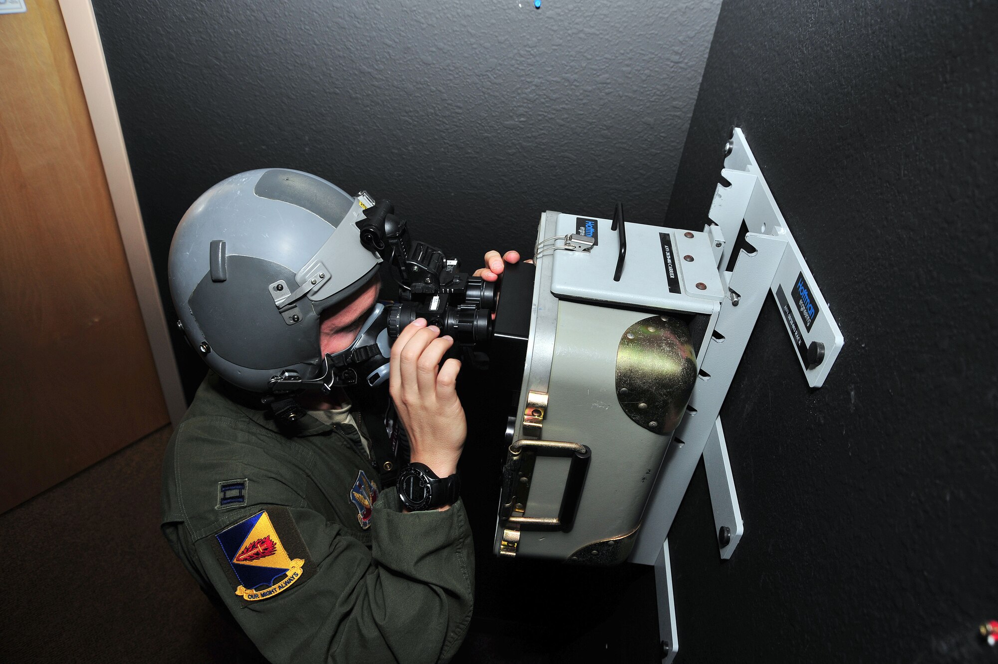 U.S. Air Force Capt. Brent Fleming, 355th Operations Group pilot, tests his night vision goggles before his flight at Davis-Monthan Air Force Base, Ariz., Nov. 7, 2013. Prior to flight, all equipment must be inspected for operability.(U.S. Air Force photo by Senior Airman Josh Slavin/Released)