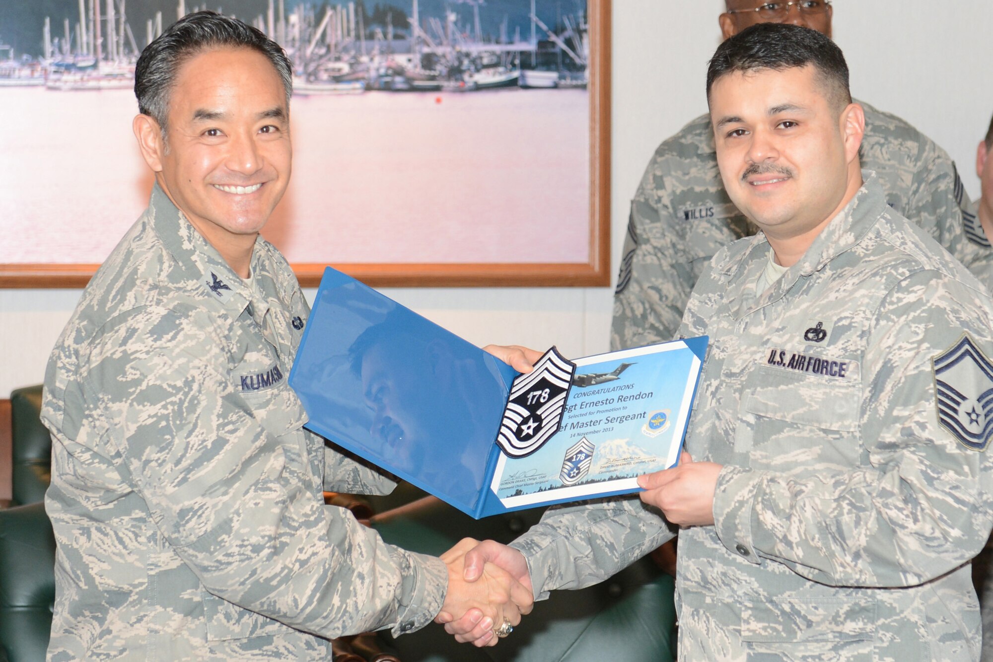 Col. David Kumashiro, 62nd Airlift Wing commander, congratulates Senior Master Sgt. Ernesto Rendon, 62nd Aerial Port Squadron air freight superintendent, on the announcement of his selection to the rank of chief master sergeant, Nov. 13, 2013 at Joint Base Lewis-McChord, Wash. This year’s Team McChord chief master sergeants selects are Rendon, Senior Master Sgt. Joe Blackman, 8th Airlift Squadron, Senior Master Sgt. Douglas Olsen, 62nd Maintenance Group, and Senior Master Trevor Smith, 4th Airlift Squadron. (U.S. Air Force Photo/ Airman 1st Class Jacob Jimenez)