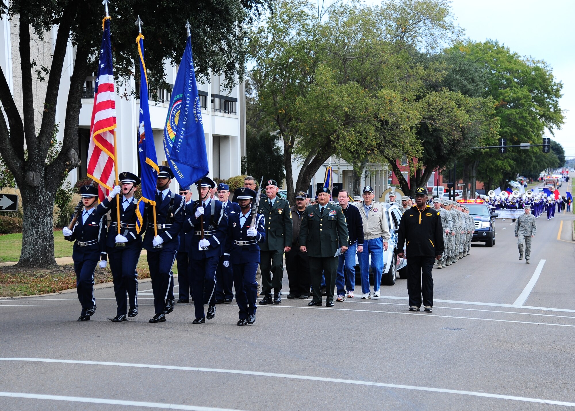 With Honor Guard leading the way, Airmen and local organizations march down Main Street during the Veterans Day Parade and Ceremony in Downtown Columbus Nov. 9. More than 50 Airmen marched and shouted cadence for the mile-long route through the city. (U.S. Air Force Photo/Airman 1st Class Stephanie Englar)