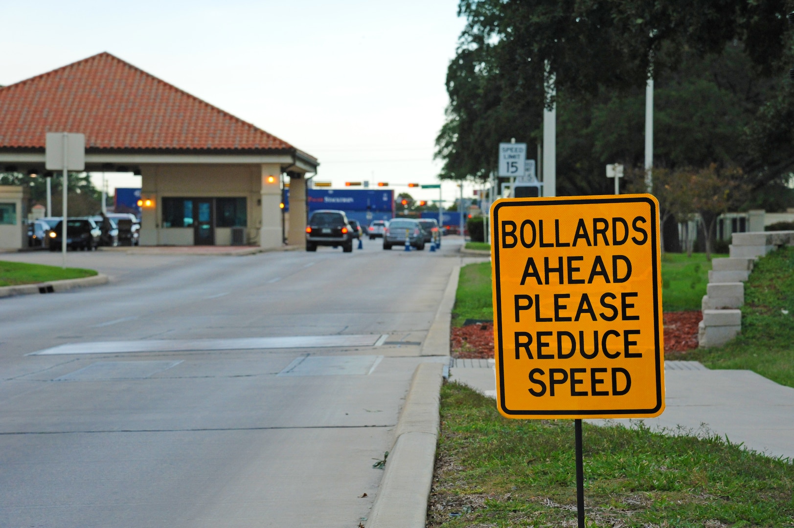 Joint Base San Antonio-Randolph members slow their vehicle speed as they navigate around the Randolph main gate bollards Nov. 7. The bollards are used for security measures and traffic control.( U.S. Air Force photo by Rich McFadden)