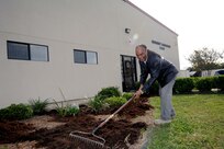 Vaughn Cropper, Joint Base San Antonio-Randolph Emergency Management Flight technician, spreads mulch as part of the 502nd Air Base Wing Pride Day Nov. 8 in front of the emergency management flight building on JBSA-Randolph. (U.S Air Force photo by Melissa Peterson)