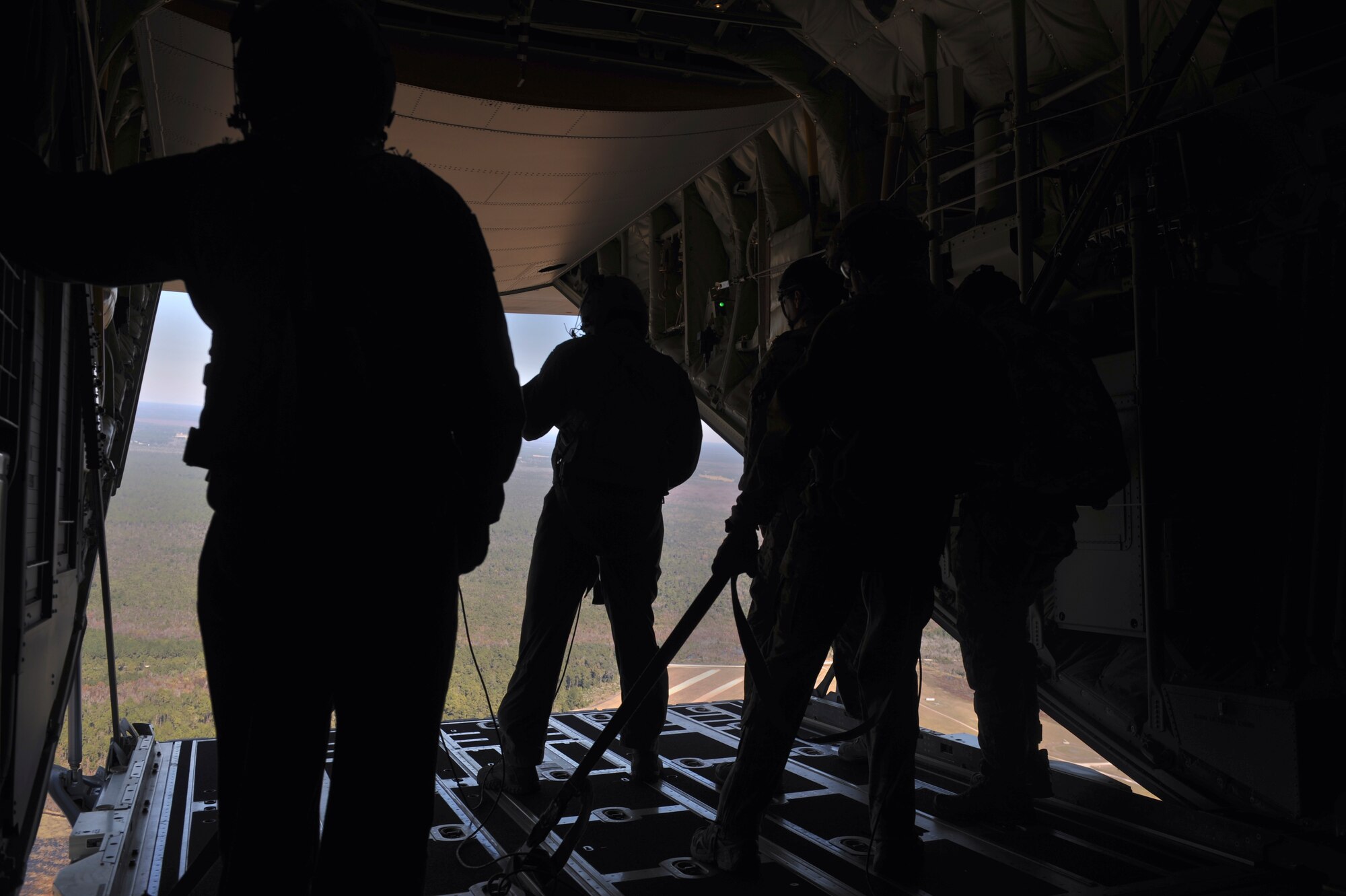 HC-130J Combat King II aircrew looks for the drop zone at Moody Air Force Base, Ga., Nov. 8, 2013.  After locating the drop zone, the primary jumpmaster readies all jumpers for the drop. (U.S. Air Force photo by Senior Airman Olivia Bumpers/Released)