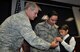 Lt. Gen. Eric E. Fiel, Air Force Special Operations Command commander, hands the Bronze Star medal to Hunter, son of Maj. F. Damon Friedman during a ceremony Nov. 13, 2013, at Hurlburt Field, Fla. Friedman, an AFSOC special tactics officer, was awarded the Bronze Star with Valor for his actions against enemy forces in Afghanistan in April 2010. (U.S. Air Force photo by Master Sgt. Carlotta Holley) 

