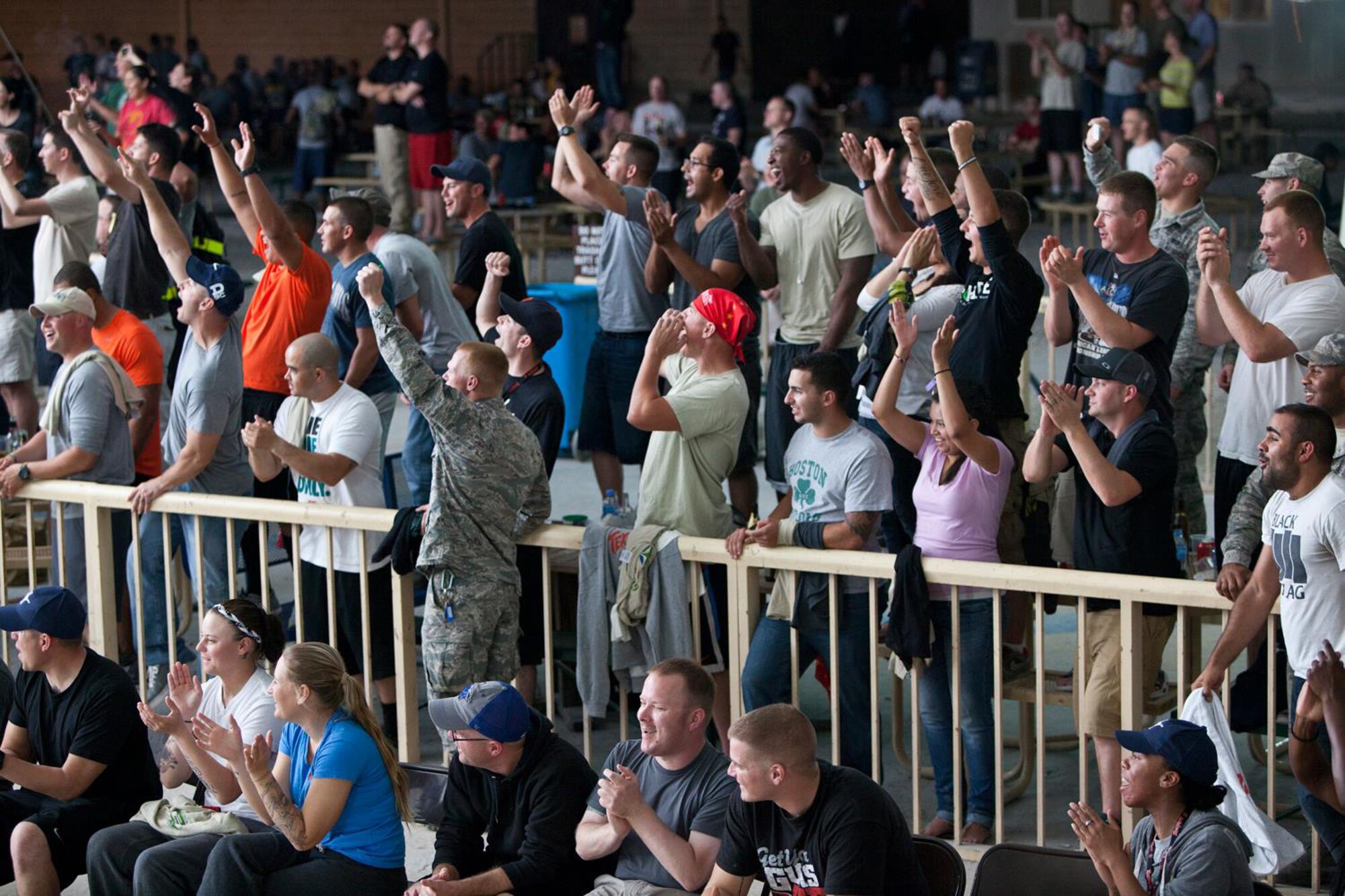 Service members cheer for members of the Bikes Over Baghdad team during a demonstration at the 379th Air Expeditionary Wing in Southwest Asia, Nov. 8, 2013. The team provided a one-hour demonstration that included a variety of stunts ranging from jumps to flat ground tricks. (Courtesy photo by Keith Mulligan)