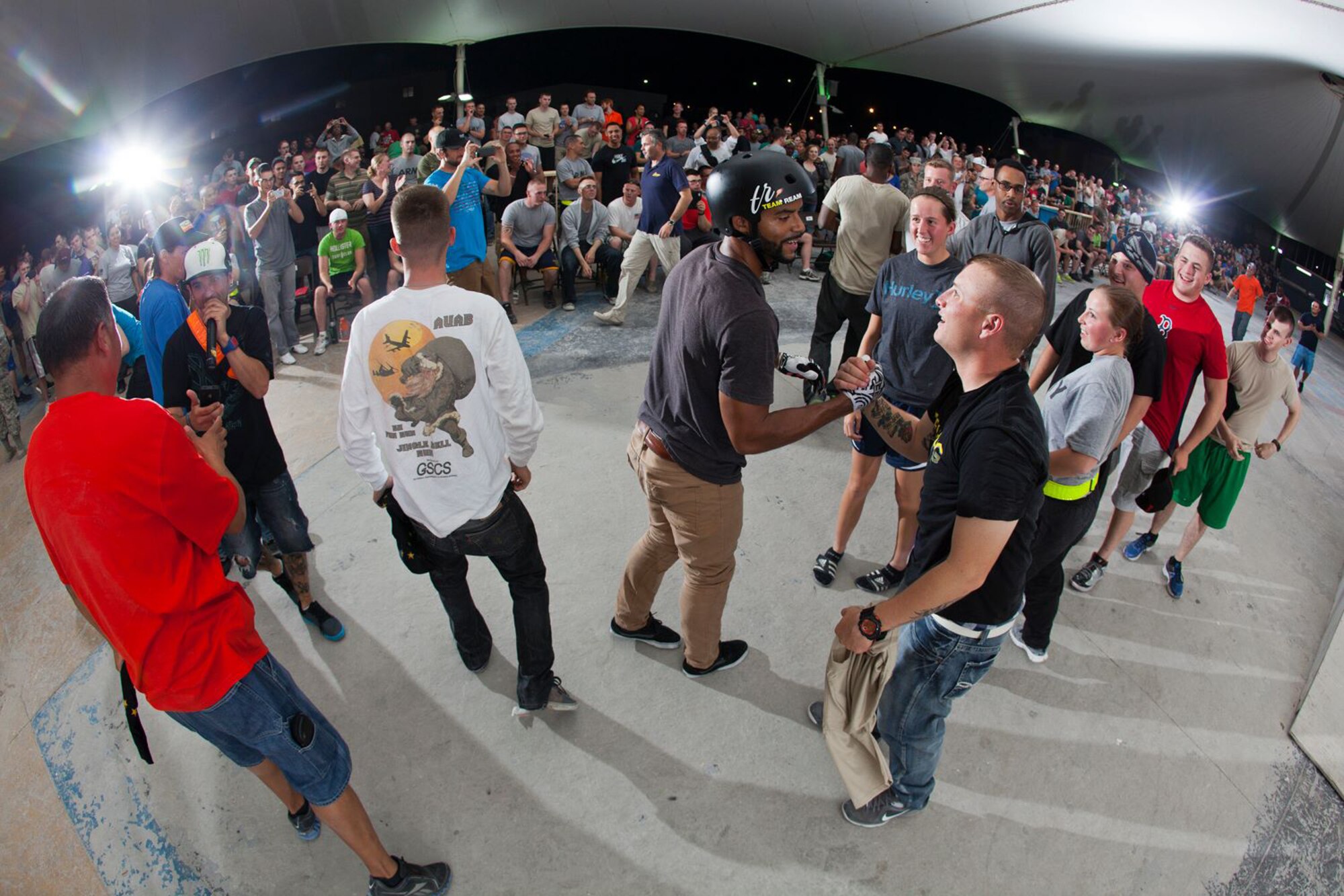 Mykel Larrin shakes hands with service members after a Bikes Over Baghdad demonstration at the 379th Air Expeditionary Wing in Southwest Asia, Nov. 8, 2013. Larrin is a professional BMX rider with the Bikes Over Baghdad group and competes in X-games competitions worldwide. (Courtesy photo by Keith Mulligan)