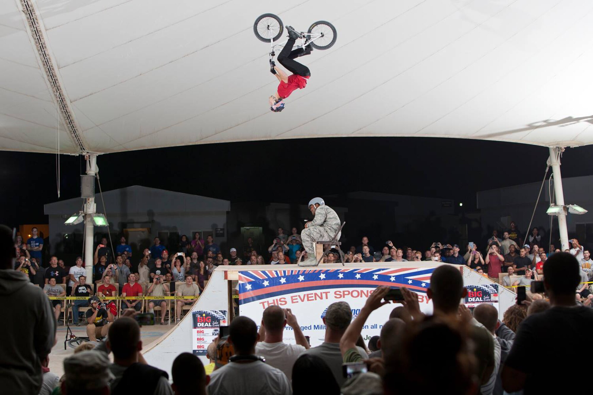 Drew Bezanson backflips over Capt. Brian Kingcade during the Bikes Over Baghdad demonstration at the 379th Air Expeditionary Wing in Southwest Asia, Nov. 8, 2013. Bezanson is a professional BMX rider with the Bikes Over Baghdad group and Kingcade is the 379th Expeditionary Force Support Squadron community services flight commander deployed from Tinker Air Force Base, Okla., and a Los Angeles native. (Courtesy photo by Keith Mulligan)
