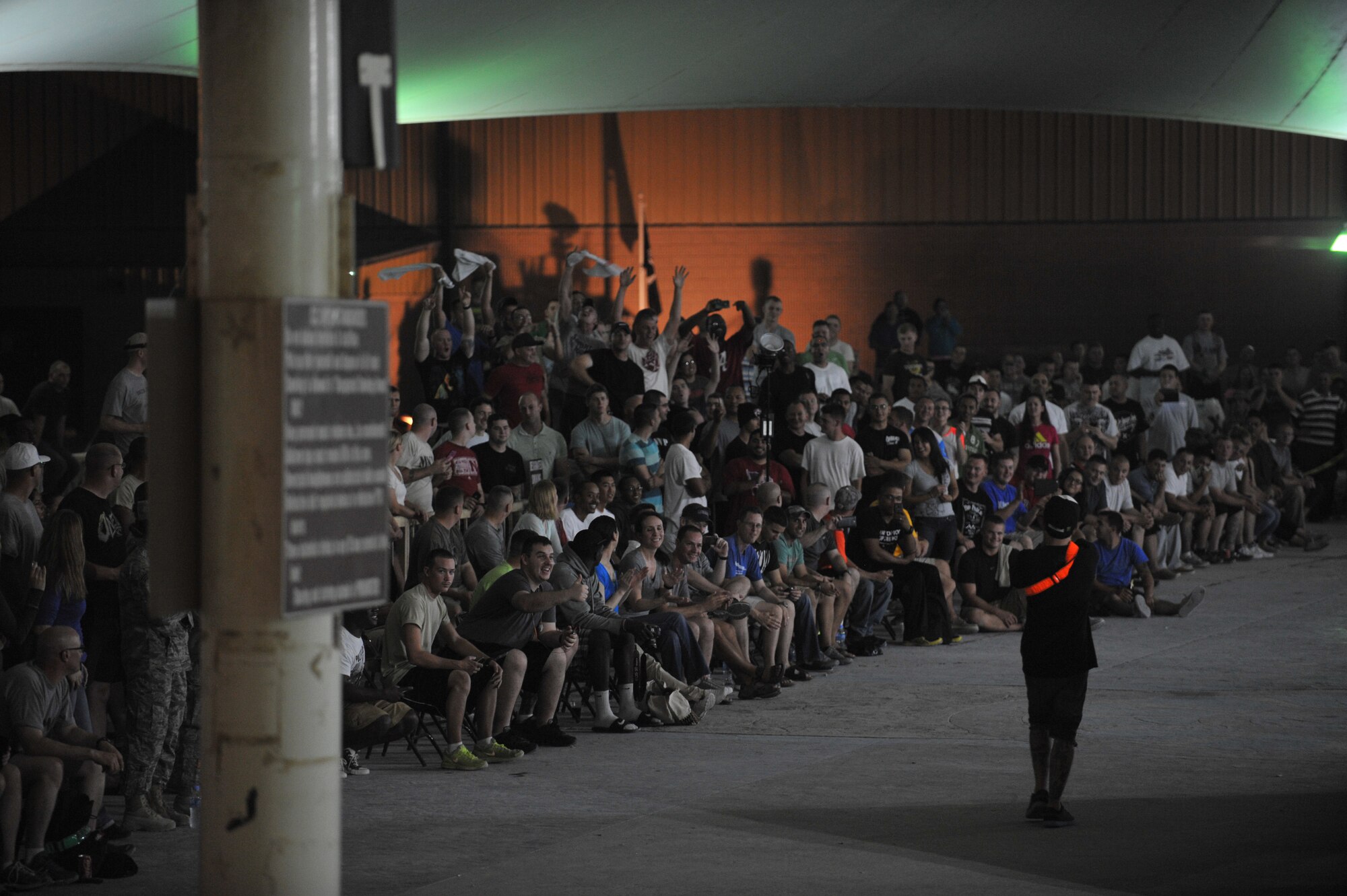 Zack Yankush talks to the crowd at the 379th Air Expeditionary Wing in Southwest Asia, Nov. 9, 2013. Yankush is a member of the Bikes Over Baghdad team and was the BOB host for the event that entertained service members. (U.S. Air Force photo/Master Sgt. David Miller)