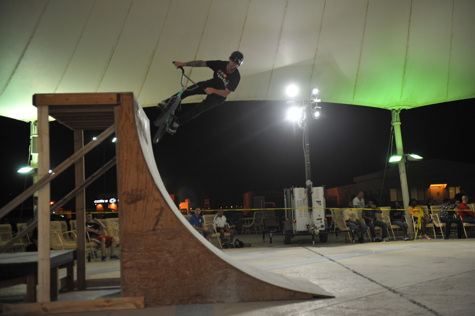 Drew Besanzon rides up a quarterpipe at the 379th Air Expeditionary Wing in Southwest Asia, Nov. 9, 2013. Besanzon is a member of the Bikes Over Baghdad group and has performed for deployed service members throughout the world. (U.S. Air Force photo/Master Sgt. David Miller)