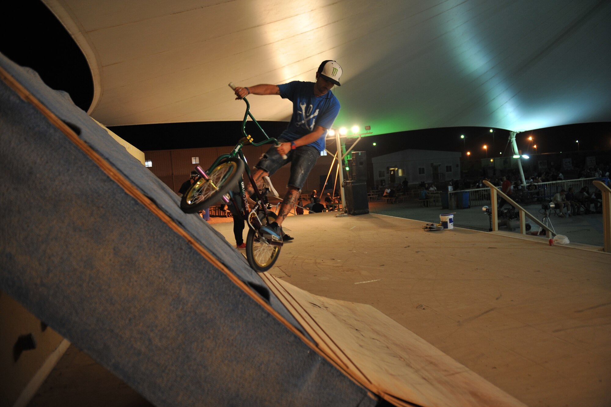 Zack Yankush rides up a ramp at the 379th Air Expeditionary Wing in Southwest Asia, Nov. 9, 2013. Yankush is a member of the Bikes Over Baghdad team and was the announcer for the event that entertained service members. (U.S. Air Force photo/Master Sgt. David Miller)