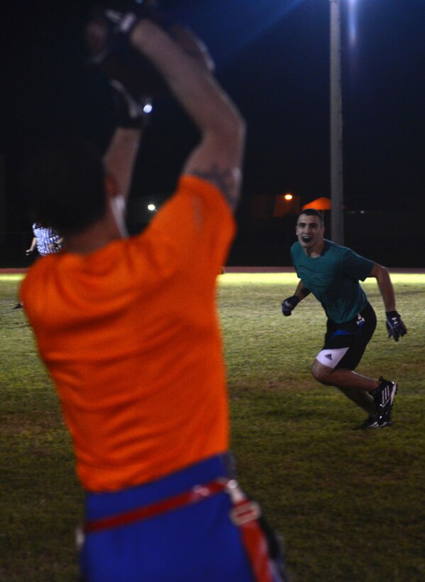 Airman 1st Class James Marker, 36th Civil Engineer Squadron, watches a player from Helicopter Sea Combat Squadron 25 make a catch Nov. 13, 2013, on Andersen Air Force Base, Guam. The Helicopter Sea Combat Squadron 25 defeated the 36th CES 40-0. (U.S. Air Force photo by Airman 1st Class Emily A. Bradley/Released)