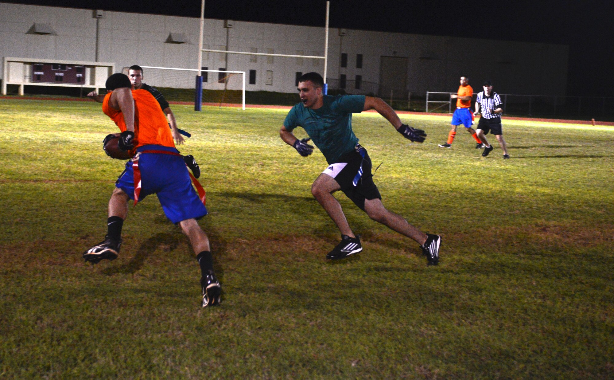 James Marker, 36th Civil Engineer Squadron, tries to grab a flag off an opponent Nov. 13, 2013, on Andersen Air Force Base, Guam. The Helicopter Sea Combat Squadron 25 intramural flag football team defeated the 36th CES 40-0. (U.S. Air Force photo by Airman 1st Class Emily A. Bradley/Released)
