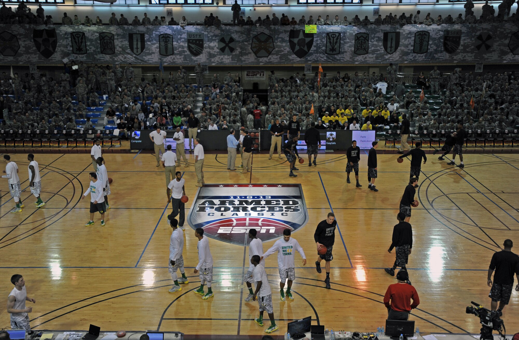 Basketball players from the University of Oregon and Georgetown University warm up before the Armed Forces Classic at U.S. Army Garrison Humphreys, Republic of Korea, Nov. 9, 2013. During the days leading up to the game, the teams served soldiers at the dining facility, conducted youth clinics, held open practices and toured Humphreys. (U.S. Air Force photo/Senior Airman Siuta B. Ika)
