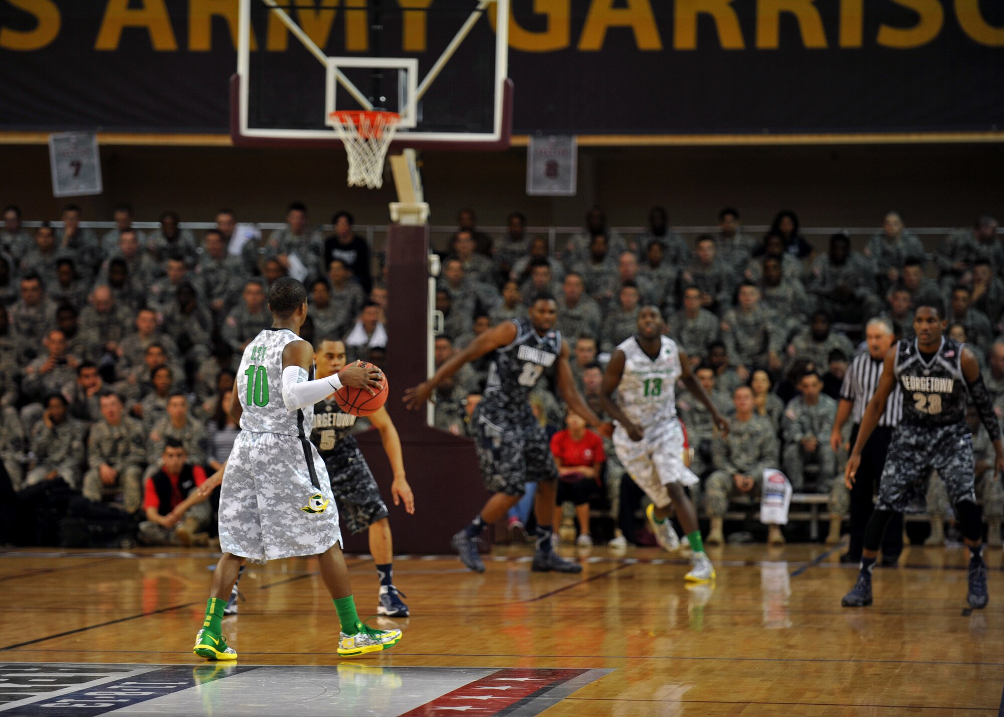 Johnathan Loyd, University of Oregon point guard, sets up a play during the Armed Forces Classic at U.S. Army Garrison Humphreys, Republic of Korea, Nov. 9, 2013. The last time a regular-season college game was held in Asia was 1982, when a Ralph Sampson-led University of Virginia and a Hakeem Olajuwon-led University of Houston played in Tokyo. (U.S. Air Force photo/Senior Airman Siuta B. Ika)