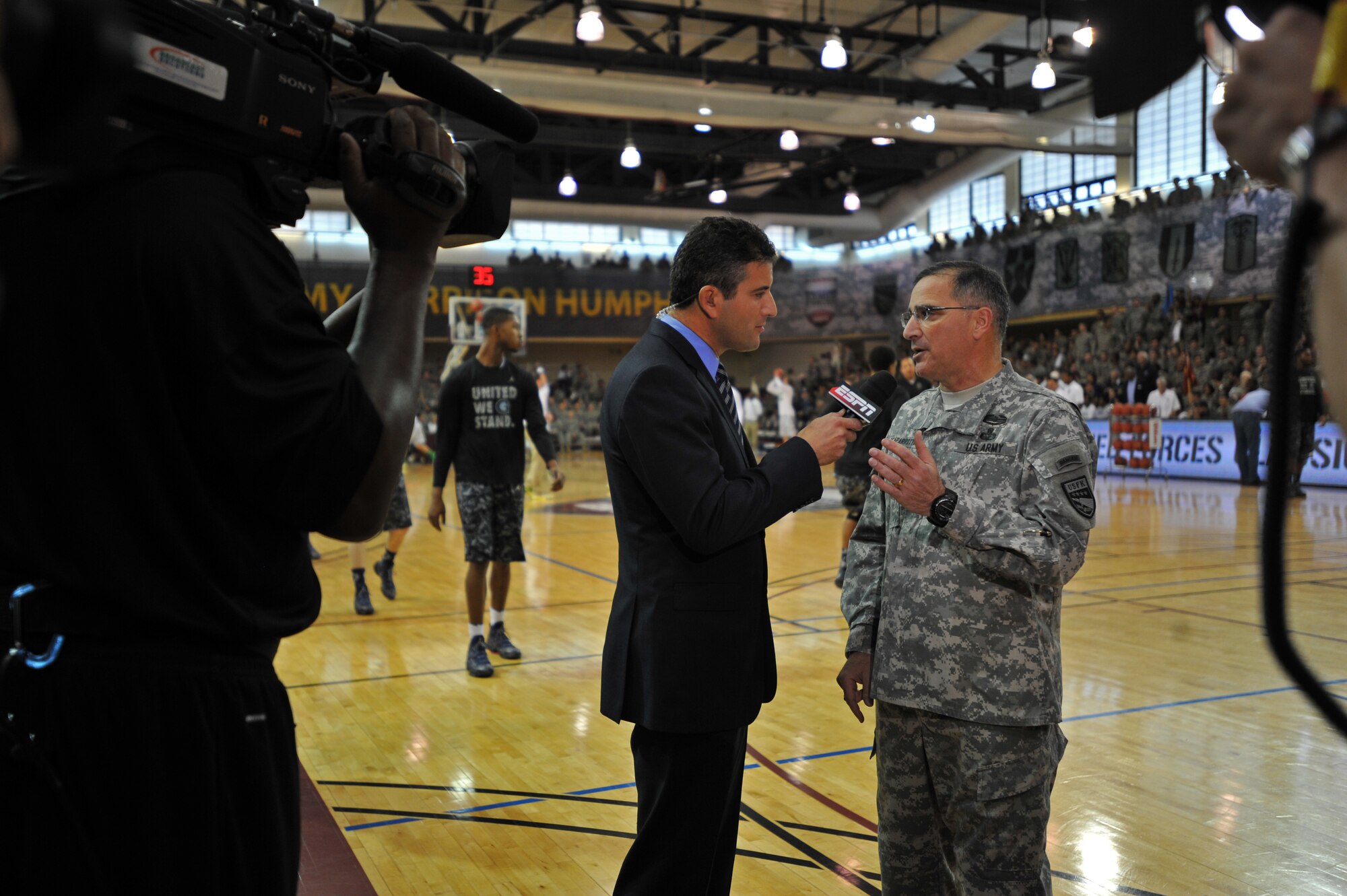 U.S. Army Gen. Curtis M. Scaparrotti, U.S. Forces Korea commander, answers questions during an interview with Andy Katz, an ESPN senior college basketball journalist, before the Armed Forces Classic tips off at U.S. Army Garrison Humphreys, Republic of Korea, Nov. 9, 2013. Hundreds of U.S. military members attended the game between the University of Oregon and Georgetown University, and witnessed Oregon’s win 82-75. (U.S. Air Force photo/Senior Airman Siuta B. Ika)