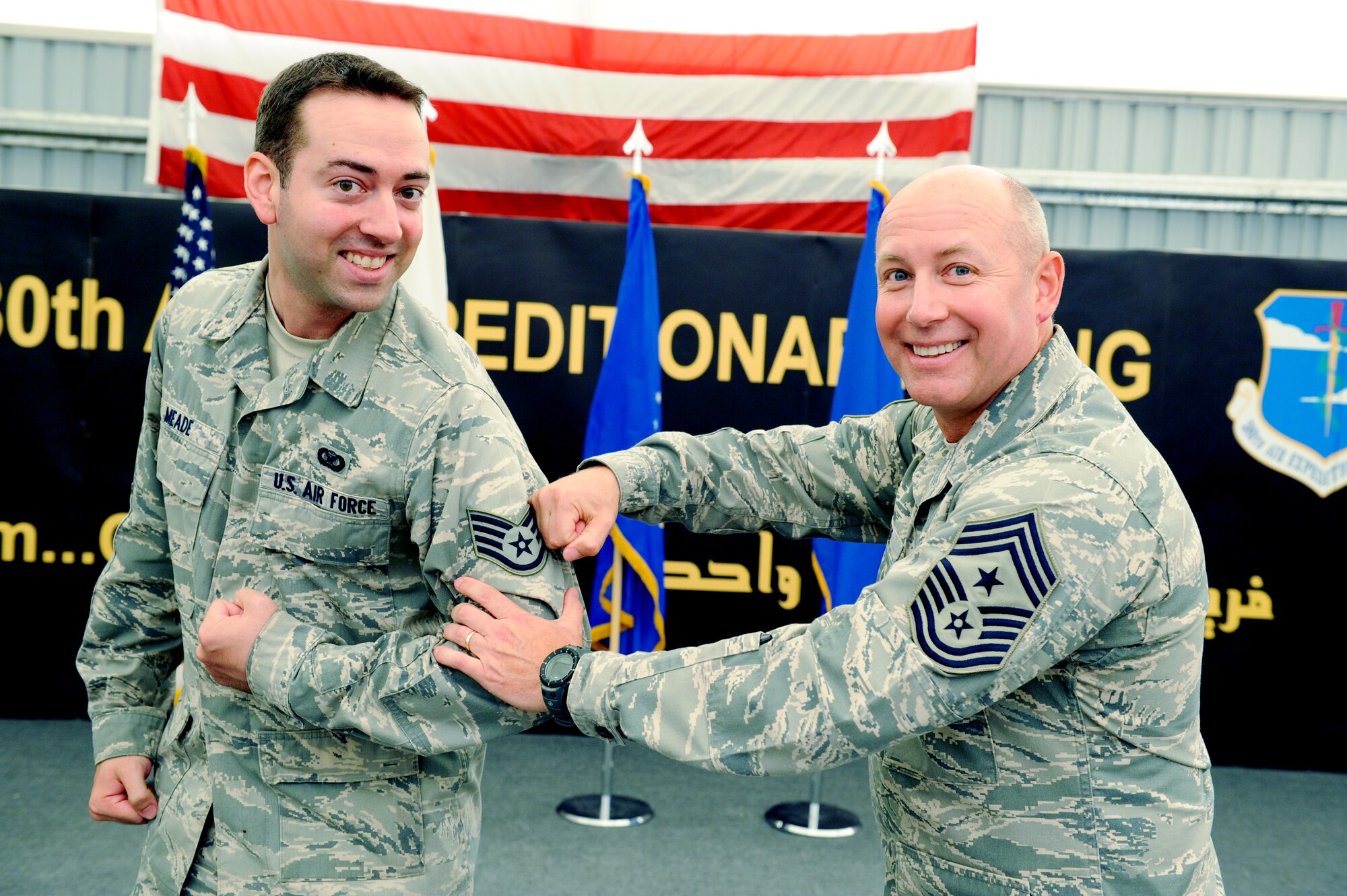 U.S. Air Force Chief Master Sgt. Garth Meade, 380th Air Expeditionary Wing command chief, pins on U.S. Air Force Staff Sgt. David Meade’s, 380 AEW broadcaster, staff sergeant stripes at an undisclosed location in Southwest Asia June 30, 2013. Garth Meade said the opportunity to see his son become an NCO has been a highlight of his deployment. (U.S. Air Force photo by Tech. Sgt. Joshua J. Garcia)