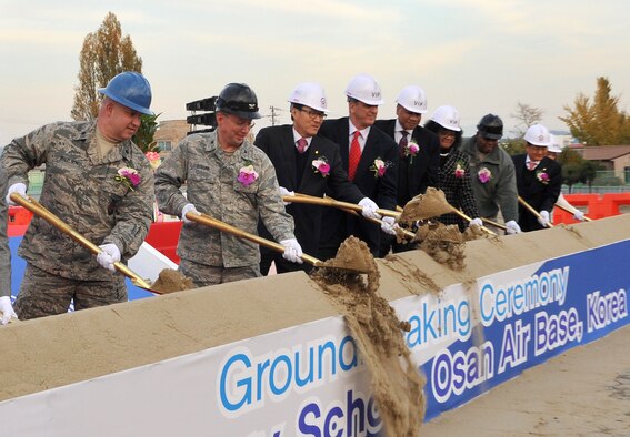 Distinguished guests break ground for the new elementary school during a ceremony at Osan Air Base, Republic of Korea, Nov. 13, 2013. The school was planned based on 21st century concepts and will be the first one of that design in the ROK. (U.S. Air Force photo/Airman 1st Class Ashley J. Thum)