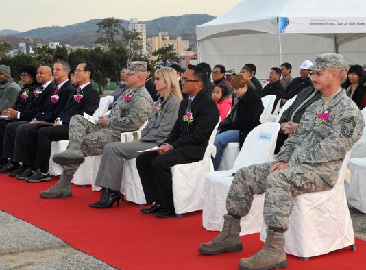 Special guests from the 51st Mission Support Group, Osan American Elementary School, U.S. Army Corps of Engineers, the South Korea District Office and ILSUNG Construction Co., Ltd., listen to guest speakers discuss plans for the new elementary school during a groundbreaking ceremony at Osan Air Base, Republic of Korea, Nov. 13, 2013. The notice to proceed with construction was given last month, and the building is slated to be operational in March 2016. (U.S. Air Force photo/Airman 1st Class Ashley J. Thum)