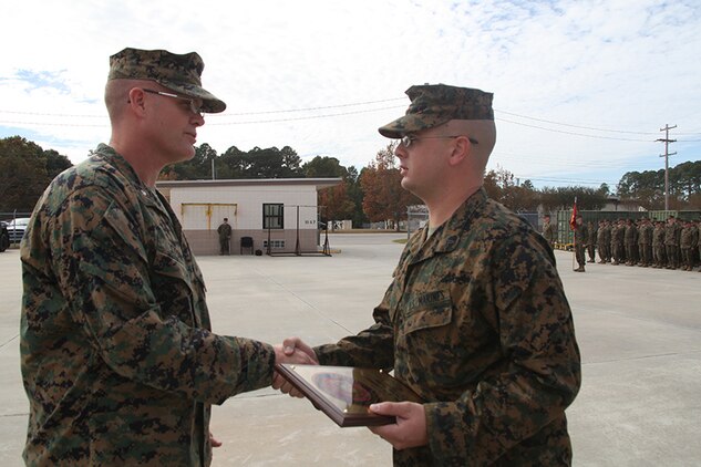 Cpl. Samuel Jarrell, a generator mechanic for Marine wing Support squadron 273, Engineer Company receives the Utilities Marine of the Year Award from Lt. Col. James Stone, the commanding officer of MWSS-273, during an award ceremony aboard Marine Corps Air Station Beaufort, Nov. 7. Jarrell received this award after more than 200 hours of heavy equipment operation, responding to 60 power generation trouble calls and providing more than 20,000 hours of uninterrupted power generation. 