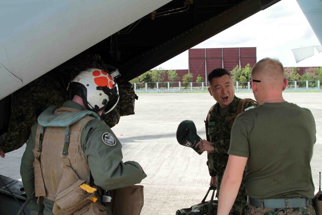 U.S. Marines at Villamor Air Base assist a medical team from the Japan Self-Defense Force onto an MV-22B Osprey headed to Tacloban Air Base, an area severely damaged by Typhoon Haiyan, during Operation Damayan, Nov. 14. The U.S. and the Armed Forces of the Philippines (AFP) have delivered more than 107,00 pounds of relief supplies, 140 relief and aid workers and more than 160 displaced personnel. Approximately 300 personnel from 3rd Marine Expeditionary Brigade have deployed in support of the efforts being orchestrated by the Government of the Philippines. (U.S. Marine Corps photo by Lance Cpl. Stephen D. Himes/Released)