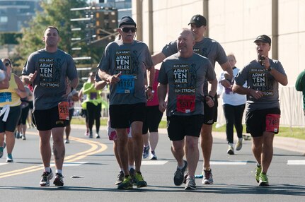 Command Sgt. Maj. Brunk W. Conley, center, the sergeant major of the Army National Guard, and retired Command Sgt. Maj. Al Hunt Jr., with glasses, the first sergeant major of the Army Guard, run toward the finish line of the Army 10-Miler, Oct. 20, 2013. Hunt, who turned 80 the day of the race, completed the run in just under three hours with Conley and other Soldiers assigned to the Army National Guard Readiness Center.