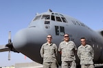 Air Force Senior Master Sgt. Steven Buchwald is flanked by his son-in-law, Air Force Senior Airman Hans Hock, left, and his son, Air Force Senior Airman Travis Buchwald, right, in front of a C-130 from their home unit, the New York Air National Guard's 107th Airlift Wing. The airmen are deployed together to Southwest Asia with the 386th Expeditionary Maintenance Group.