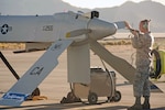 California National Guard Airman 1st Class Allan Polzin, 163d Aircraft Maintenance Squadron, conducts pre-flight checks on the MQ-1 Predator while in communication with the pilots prior to a training flight at Southern California Logistics Airport in Victorville, Calif., Nov. 3, 2012.