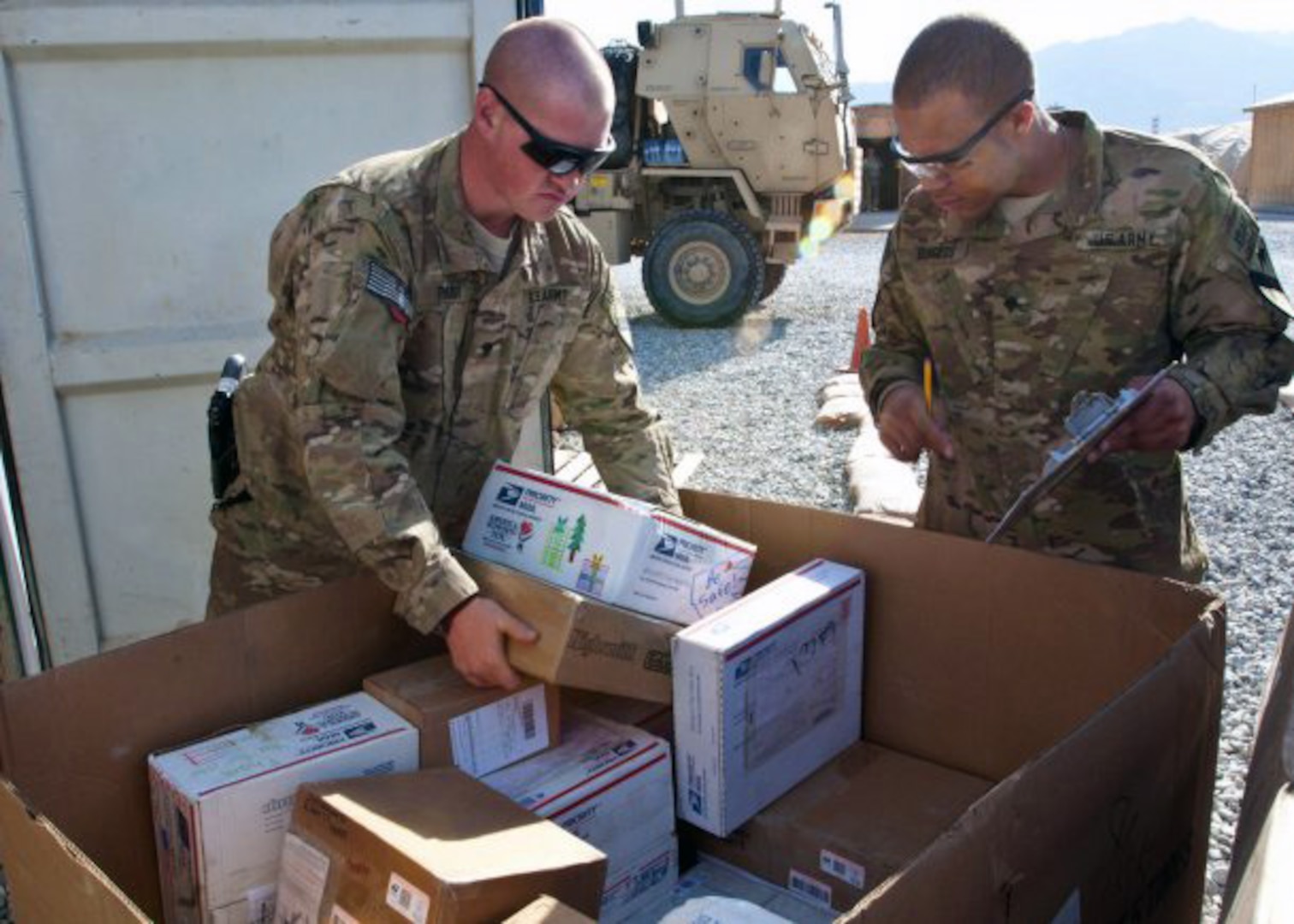 Soldiers at Forward Operating Base Gamberi, Afghanistan, process holiday mail last December.