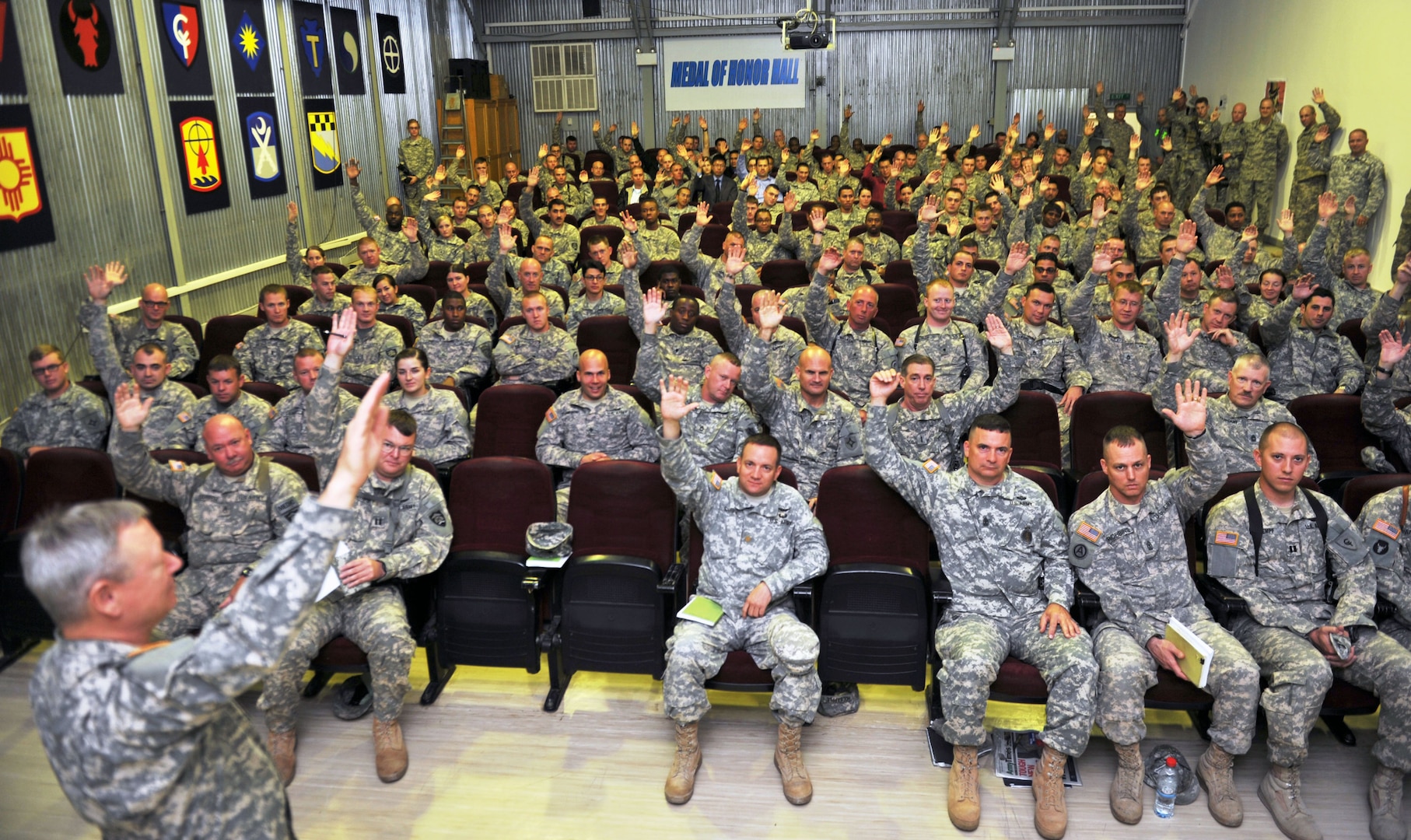 By a show of hands, Guard members deployed to Kosovo indicate to Army Gen. Frank Grass, the chief of the National Guard Bureau, and Air Force Chief Master Sgt. Mitch Brush, the chief's senior enlisted advisor, how many have completed state active duty missions for domestic responses before they deployed, Nov. 6, 2013.