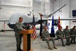 New York Air National Guard Commander Maj. Gen. Verle Johnston speaks during the ribbon cutting officially opening the MQ-9 Launch and Recovery Element Hangar on Nov. 5, 2013.