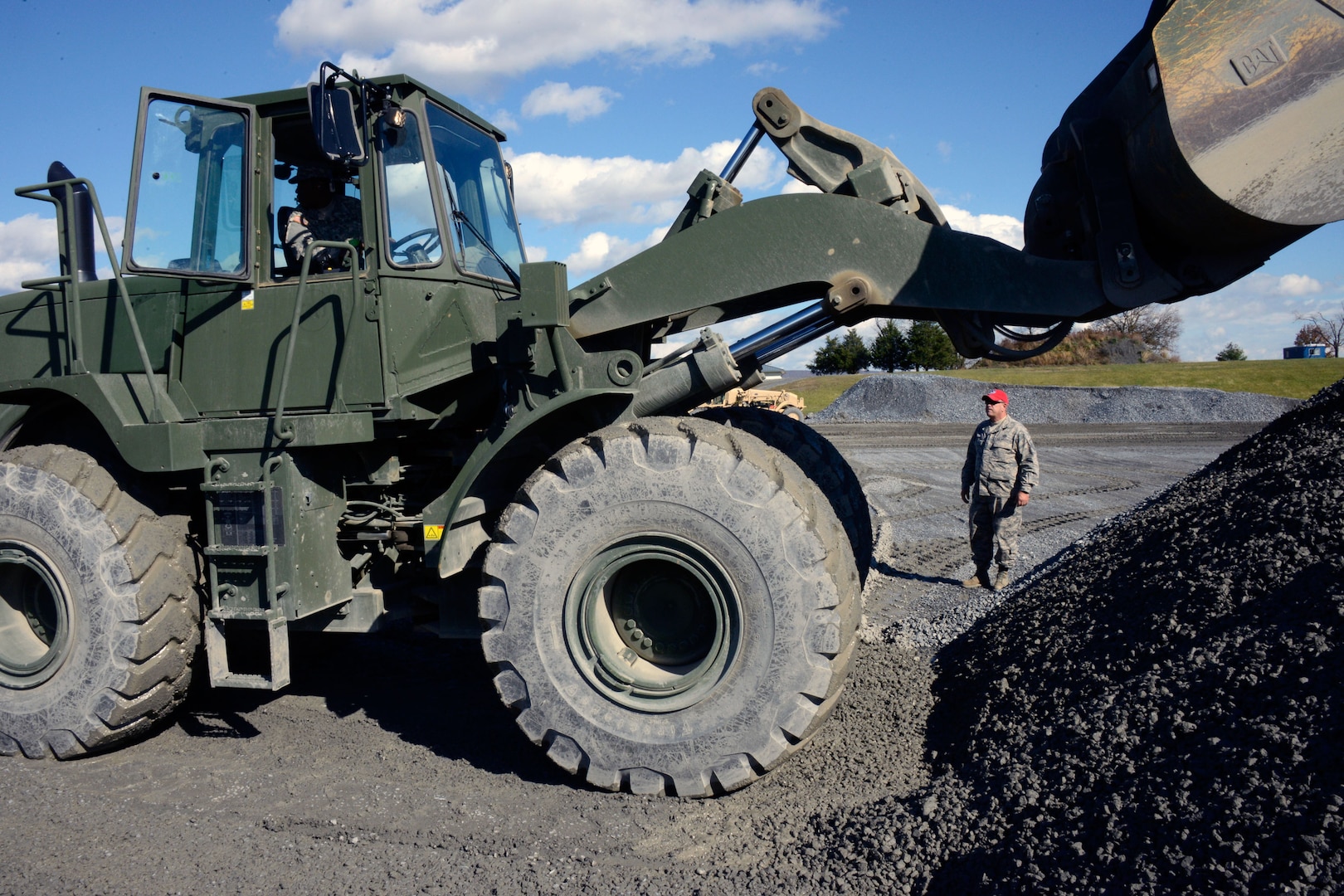 Master Sgt. Russ Krause, noncommissioned officer in charge of REOTS, observes an Army National Guard student backing up a front-end loader during the heavy equipment operator's course.