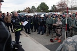 Soldiers of the Massachusetts Army National Guard and members of the Federal Emergency Management Agency's Urban Search and Rescue Task Force 1 receive a briefing before heading to the site of a simulated collapsed building during Maine's Vigilant Guard Exercise on Nov. 6, 2013.