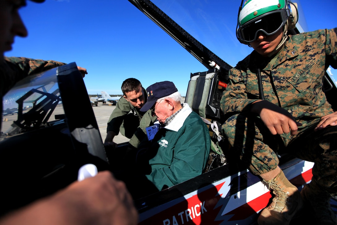 Marines with Marine Fighter Attack Squadron 115 explain the capabilities of the F/A-18 Hornet to retired Maj. William H. Hodson, a VMFA-115 alumnus, during the annual VMFA-115 reunion held aboard Marine Corps Air Station Beaufort, Nov. 8. Hudson, a 90-year-old native of Tacna, Ariz., was a former pilot with the squadron when it was first commissioned in 1943. Activated on July 1, 1943, VMFA-115's reunion was part of the squadron's 70th anniversary celebration.