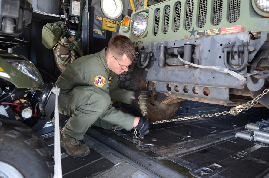 Senior Airman Timothy Oberman secures a Humvee inside an aircraft, Nov. 14, 2013, at Andersen Air Force Base, Guam, before departing insupport Operation Damayan in Tacloban, Philippines.  The U.S. military’s ability to respond rapidly to the Philippine government’s request reaffirms the value of the close cooperation our two nations share. The Filipino people are responding to this setback with characteristic resilience, aided by the effective measures their government took to help prepare them for the storm. Oberman is a 36th Airlift Squadron C-130 Hercules loadmaster.